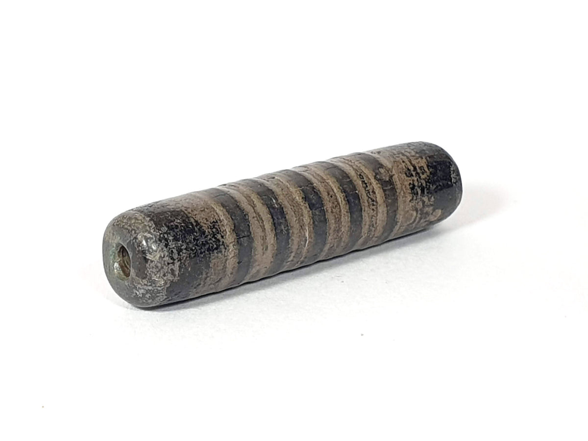 Ac-080420-19SChung, Bead B right end, large drill hole with reddish-brown interior, encrusted dark end cap, unretouched