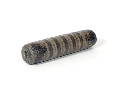Ac-080420-19SChung, Bead B right end, large drill hole with reddish-brown interior, encrusted dark end cap, unretouched