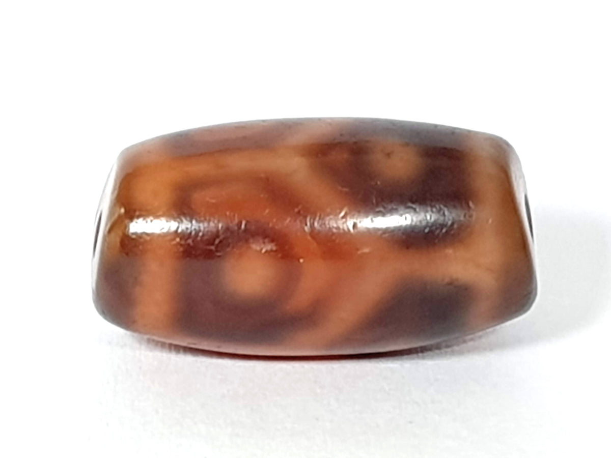 Antique six-eye lotus dzi bead, brown agate, natural patina, cream motif patterning, visible drill holes, barrel shape