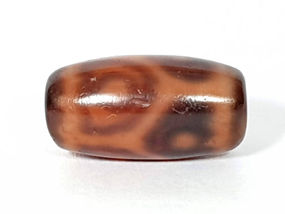 Antique six eye dzi bead, dark brown agate, lotus motif pattern, natural patina, oval barrel shape, weathered surface texture