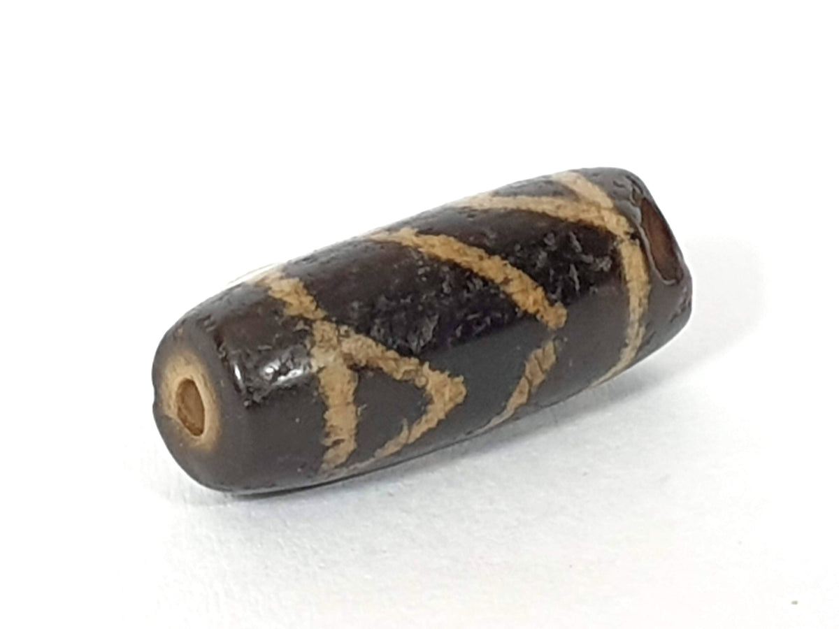 Ac-071026-CBEV2 ancient beveled carnelian angled view significantly chipped drill end intact hole unretouched