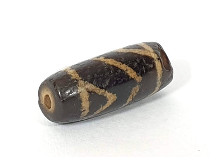 Ac-071026-CBEV2 ancient beveled carnelian angled view significantly chipped drill end intact hole unretouched