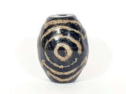 Ancient Triple Heaven's Gate Dzi Bead, dark agate, cream spiral motif, visible drill hole, aged patina, oval barrel shape