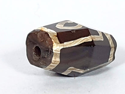 At-120120-2E7, octagonal end face with drilled hole, ancient weathering and oxidation around hole, unretouched