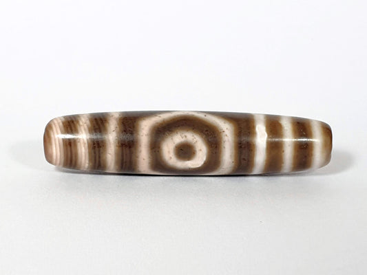 Qing Dynasty three eye dzi — front face, one large open eye centred, speckled cream zones, warm brown ground, At-0426-3EQ2