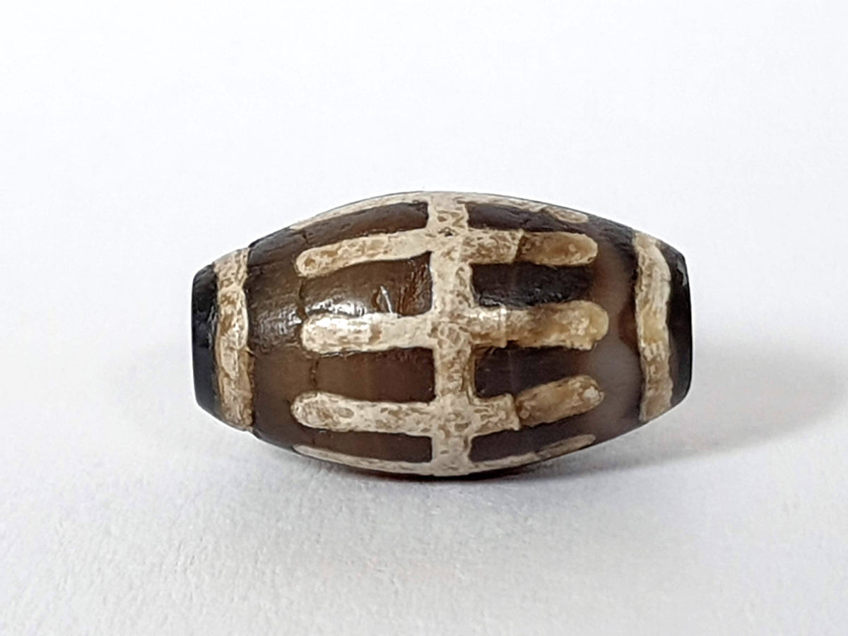Ac-062426-SR Bead A warm chocolate-brown ground raised mineralised sun ray bars end view drill hole unretouched