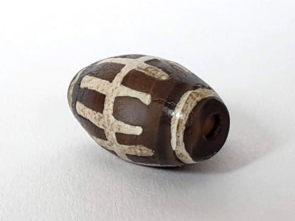 Ac-062426-SR Bead A warm chocolate-brown ground raised mineralised sun ray bars end view drill hole unretouched