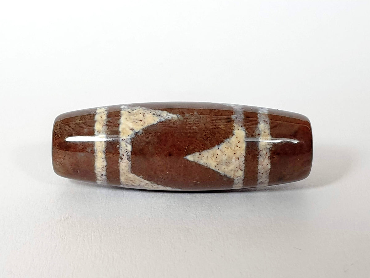 N-062426-TTBS Bead A tiger tooth dzi 39.4x13.6mm opposite end warm reddish-brown agate natural striation unretouched