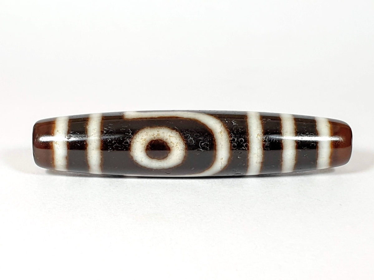 Vintage two-eye dzi bead, brown and black agate with white striping and natural patina, 54.5mm