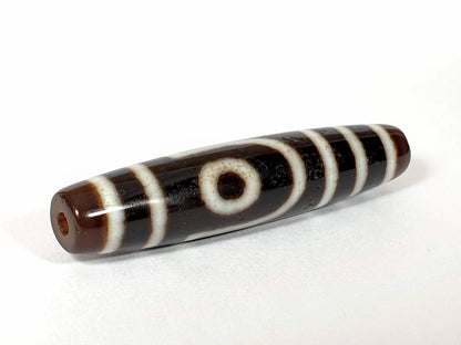 Vintage two-eye dzi bead, brown and black agate with cream striping and natural patina, 54.5mm