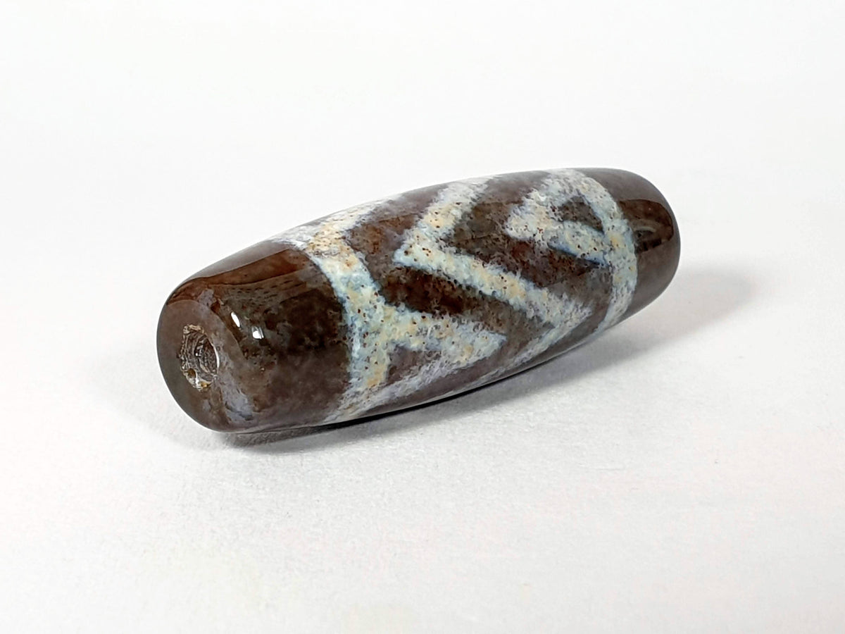 Three stripe tiger agate dzi bead with bloodspots, natural brown and white patterning, polished surface, drilled.