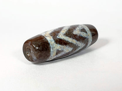 Three stripe tiger agate dzi bead with bloodspots, natural brown and white patterning, polished surface, drilled.