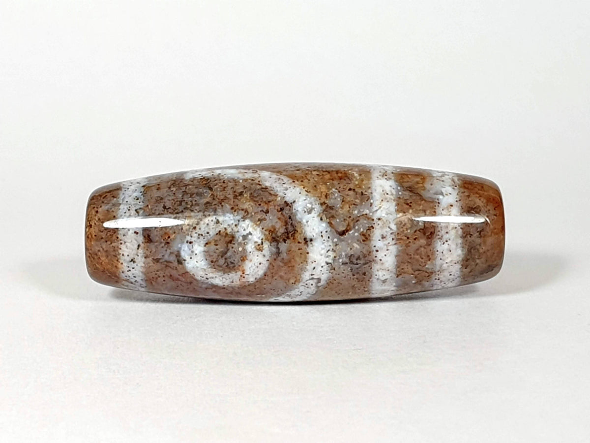 N-062126-2E2 dzi bead, opposite side profile, second eye face, unretouched