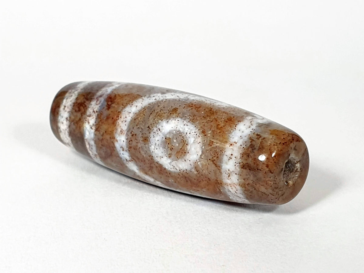 N-062126-2E2 dzi bead, straight side profile, tighter eye face visible, unretouched