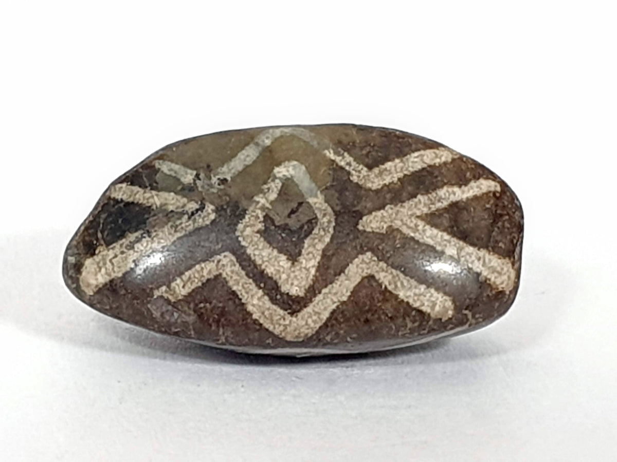 Rare triangular antique dzi bead, brown agate, white zigzag wave and diamond eye motifs, aged patina, natural etching