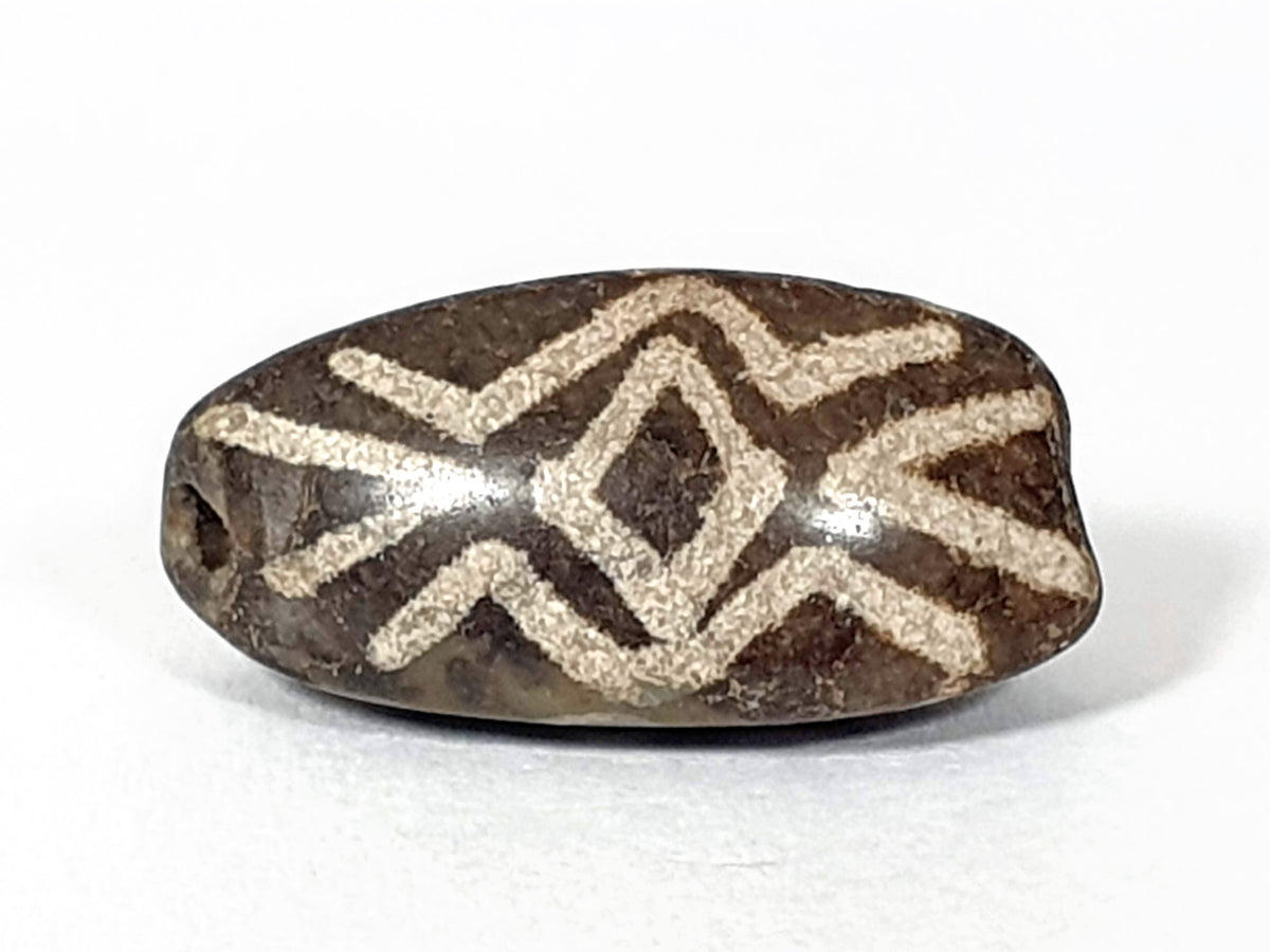 Antique triangular dzi bead, brown agate, white etched three diamond eye tiger tooth motif, visible drill hole, aged patina