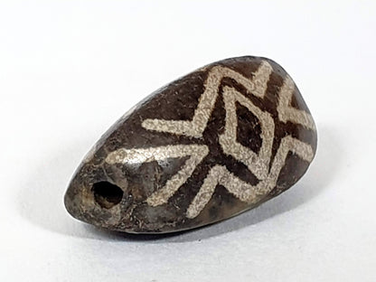 Antique triangular dzi bead, three diamond eye tiger tooth motif, brown agate, etched white pattern, visible drill hole, aged patina