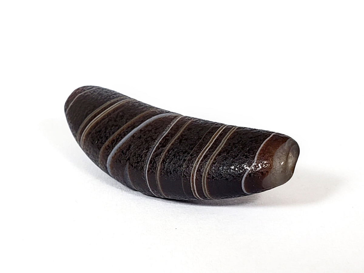 Natural banded agate dzi bead with bow shape and striped pattern, dark brown and black coloring