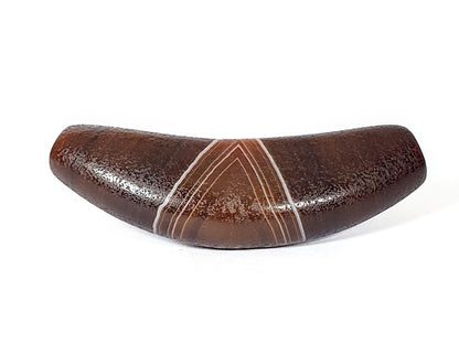 Bow-shaped natural banded agate Dzi bead with white striped pattern, brown polished surface, and drilled center hole