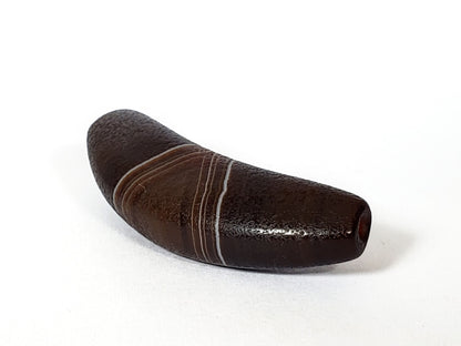 Bow-shaped natural banded agate dzi bead with brown and white stripes, polished surface, and center drill hole