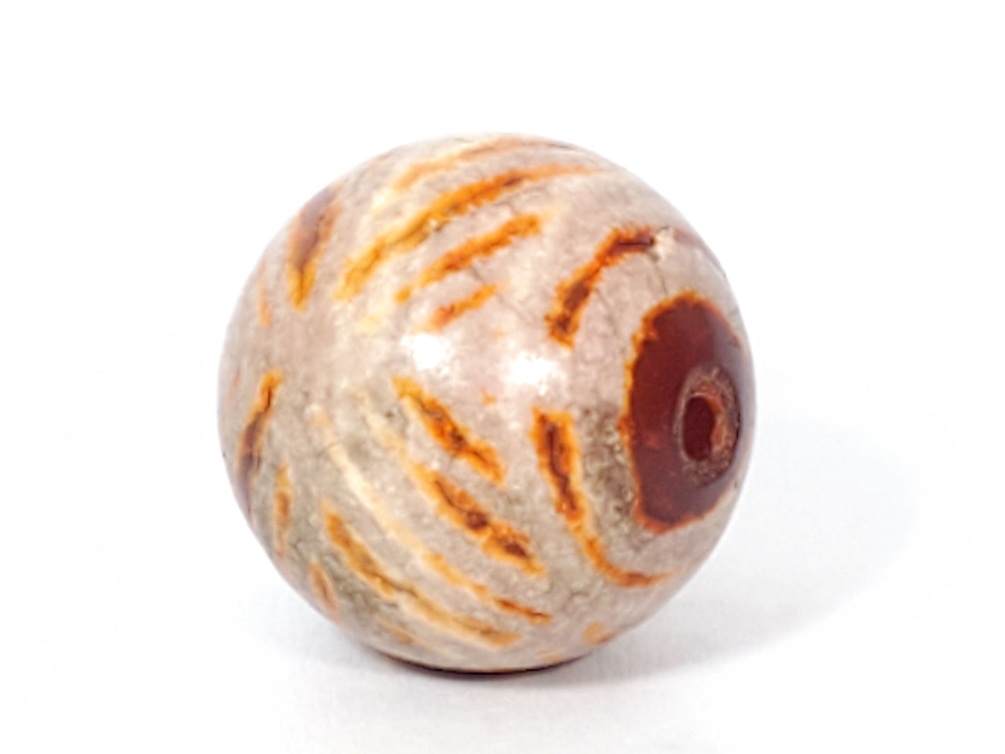 Ac-030623-DDIE ancient double diamond eye carnelian dzi, drill end view, dark carnelian zone, drill hole, unretouched