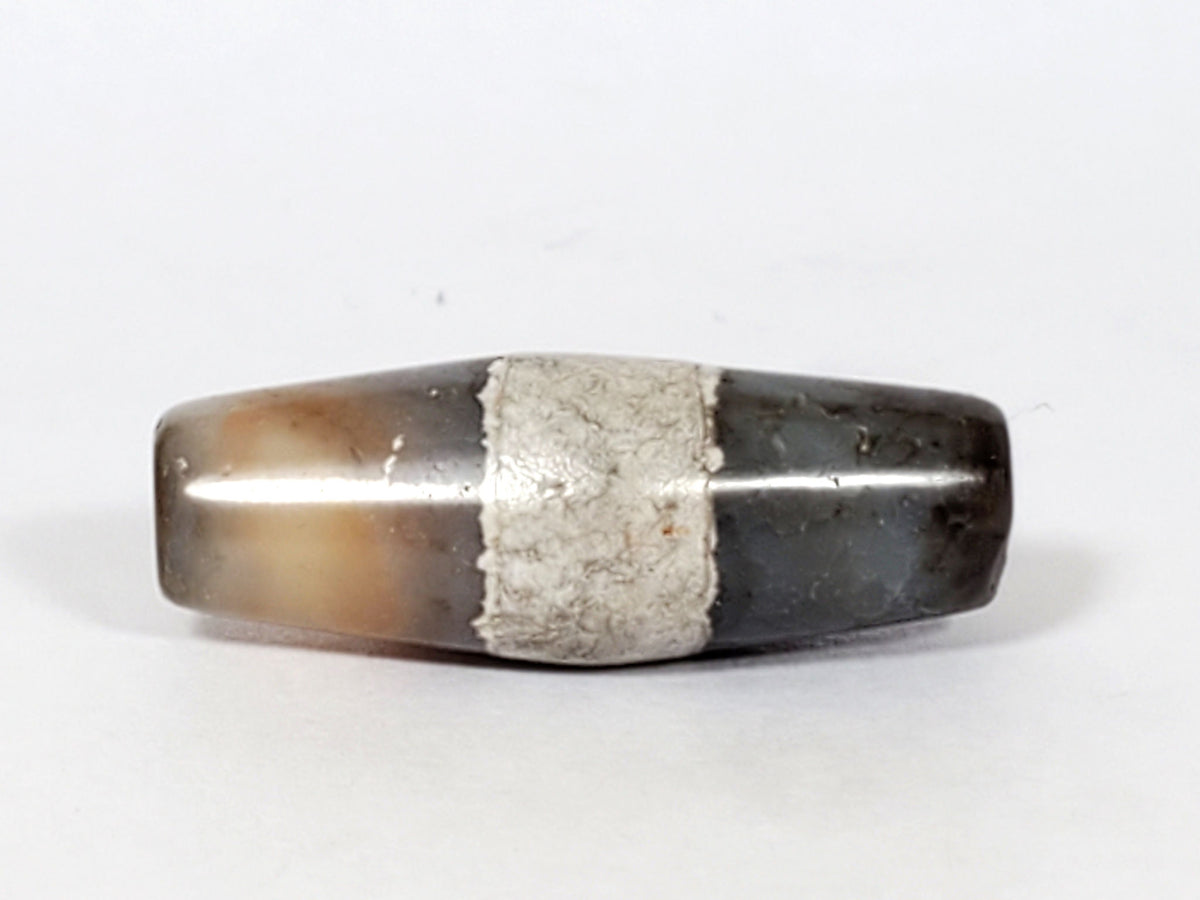 Ac-061526-1SPair, Bead A Face C, uniform pale grey-white ground, calcification band, bright mineral line visible, unretouched