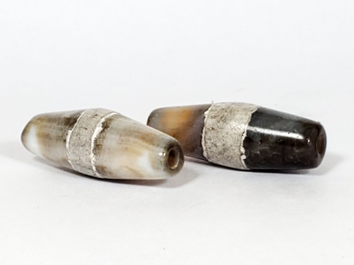 Ac-061526-1SPair, Bead B Face C, deep dark grey-brown ground, calcification band, end cap chip area visible, unretouched