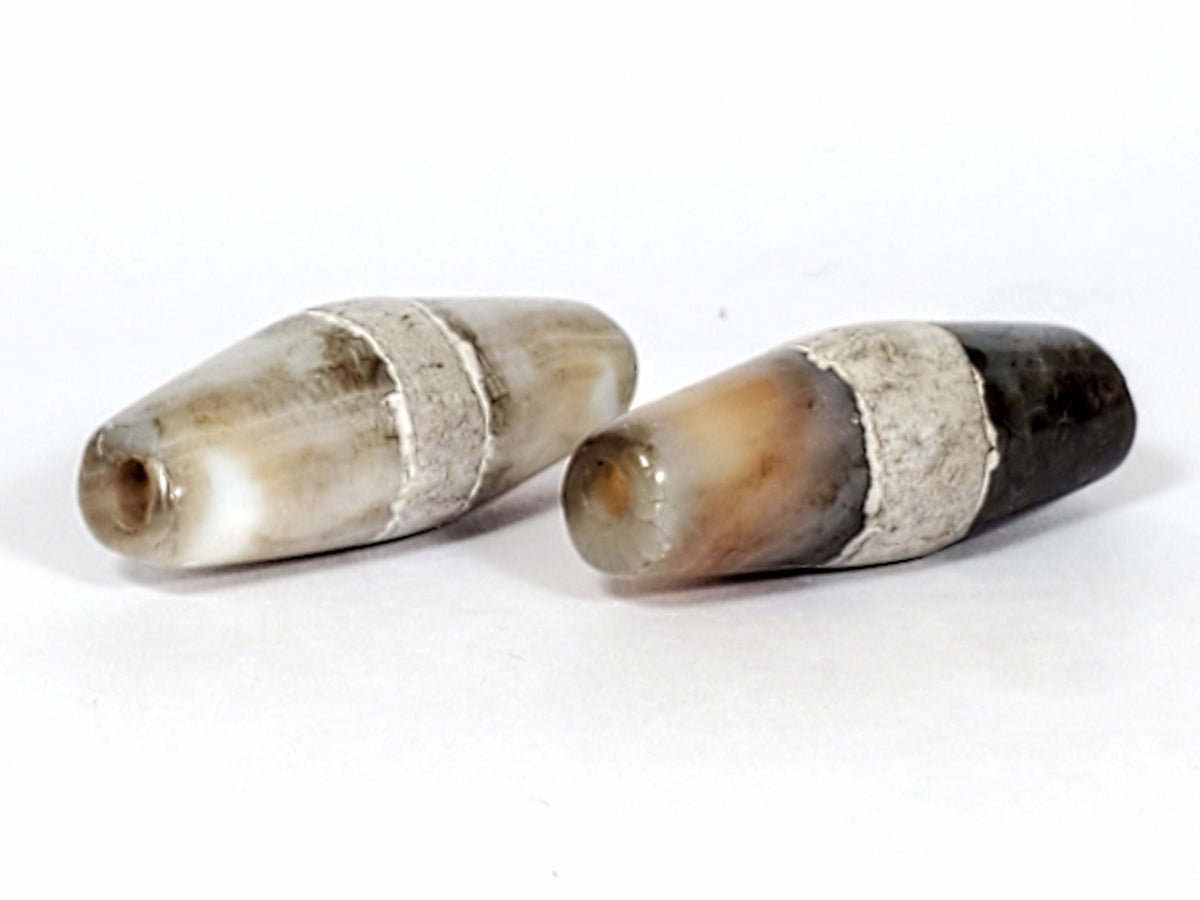 Ac-061526-1SPair, Bead A, 25.4×9.2mm, pale grey-white bicone, calcification stripe, honey-brown banding, unretouched