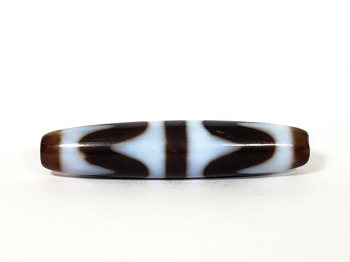 N-062226-DW3, face B, very deep dark brown agate, bilateral wave forms flanking central bar, cool white field, unretouched