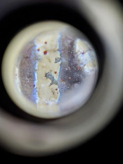 Nine-eye dzi bead with bloodspots, natural agate patterns in cream and grey tones, traditional Tibetan design