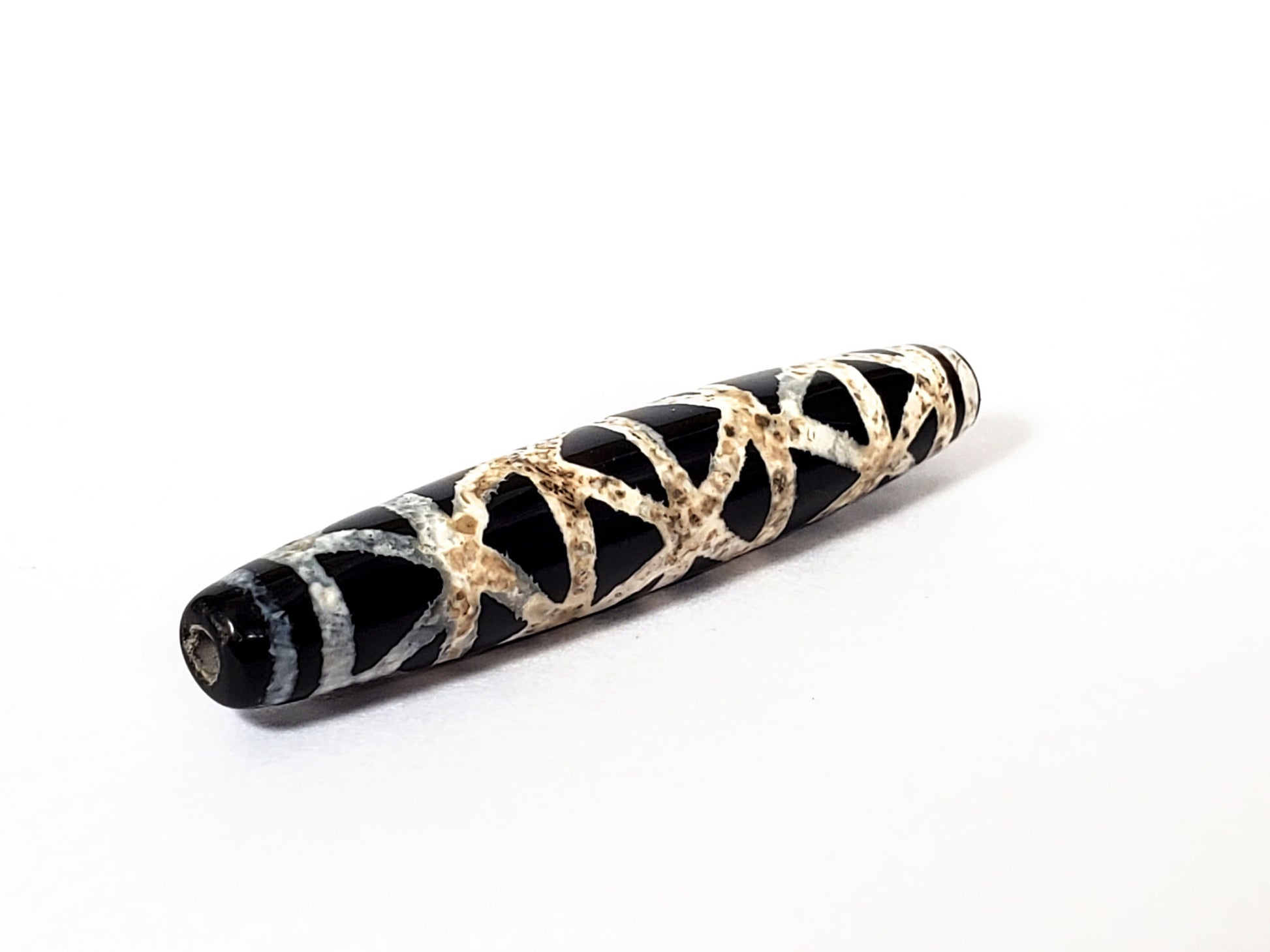 Ac-062426-CCX Bead B criss-cross carnelian dzi 48.9x9.1mm very deep near-black ground cream lattice unretouched