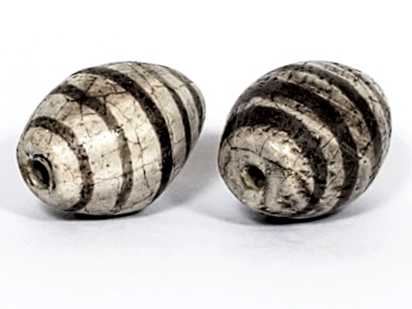 Ac-062626-9SChung2 pair ancient Chung dzi, drill end view, stripe softening age detail visible, unretouched