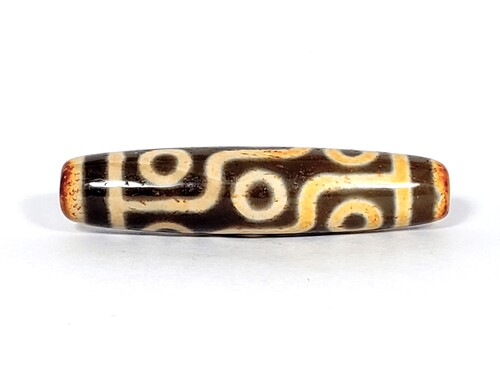 Decorative dzi bead with intricate nine eye pattern
