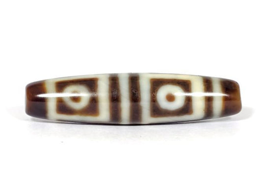 V-070226-4E vintage four eye dzi bead, front view, cream-white ground with dark brown motif, 49.4×11.9mm, unretouched.
