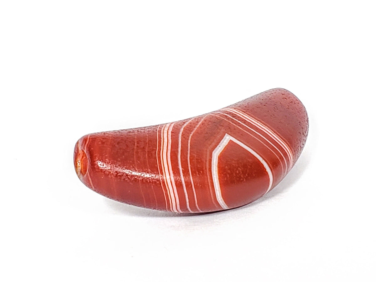 Natural banded agate dzi bead with bow stripe pattern, red and white striations, polished surface
