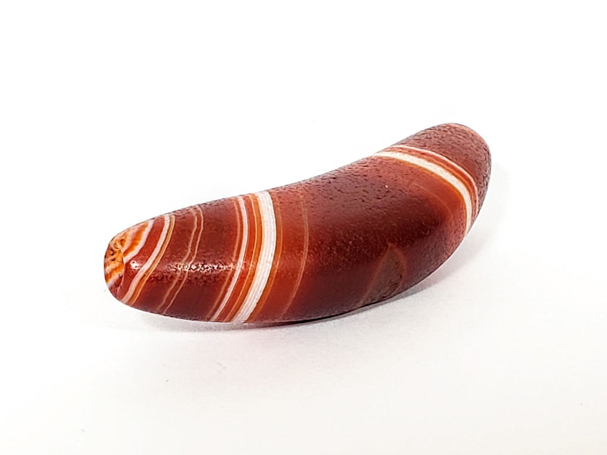 Bow-shaped natural banded agate dzi bead with white stripes and reddish-brown bands, polished surface