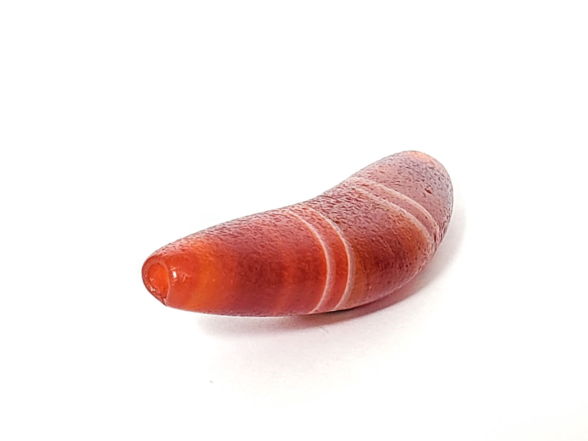 Bow-shaped natural banded agate dzi bead with red and pink striping and polished surface