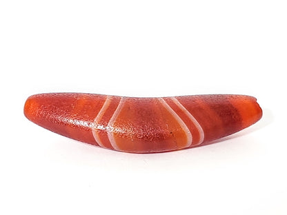 Bow shaped natural banded agate dzi bead with red-orange striping and translucent bands