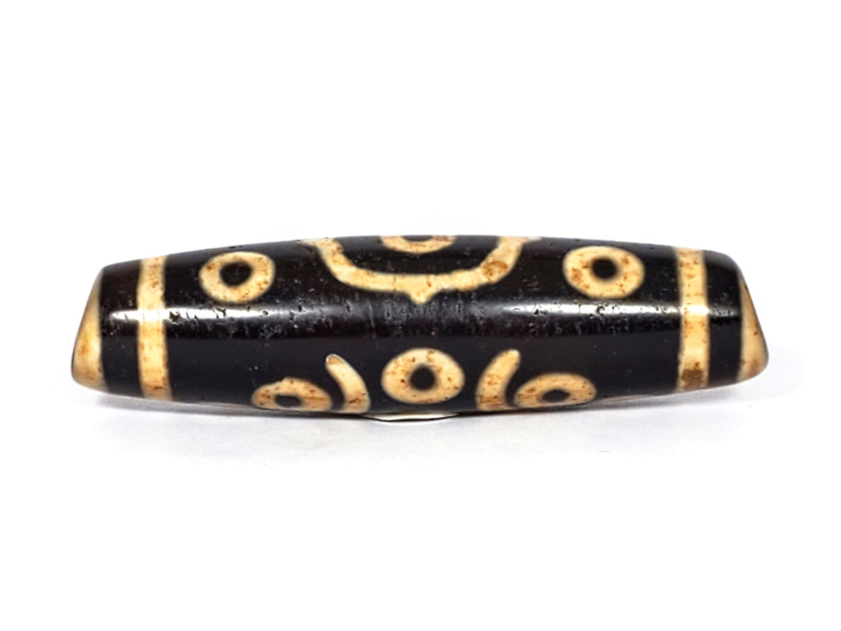 V-FA-062126-14E-LK dzi bead, opposite side profile, honey-gold motif on black ground, unretouched