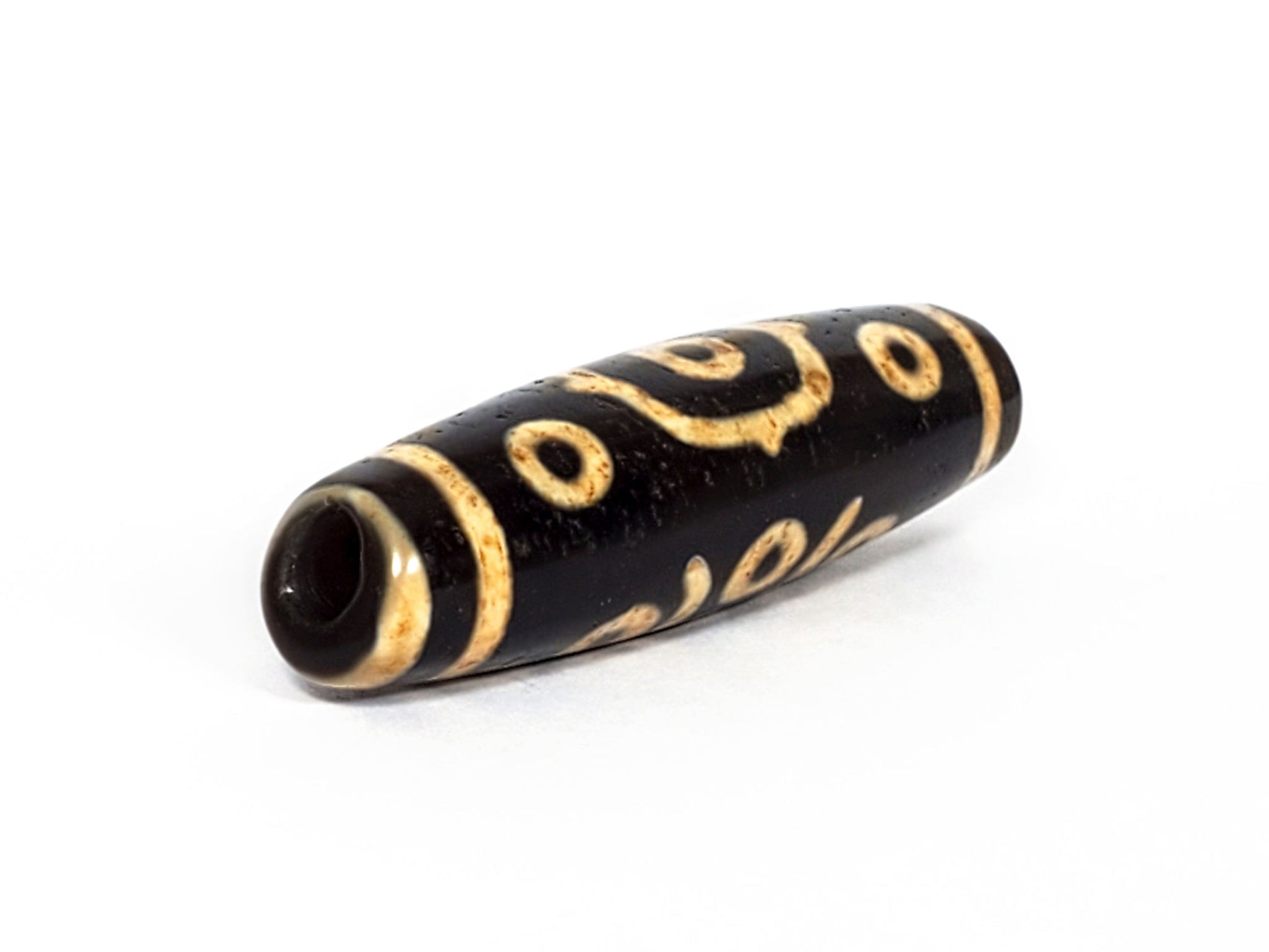V-FA-062126-14E-LK dzi bead, opposite angled view showing large keyhole drill hole, unretouched