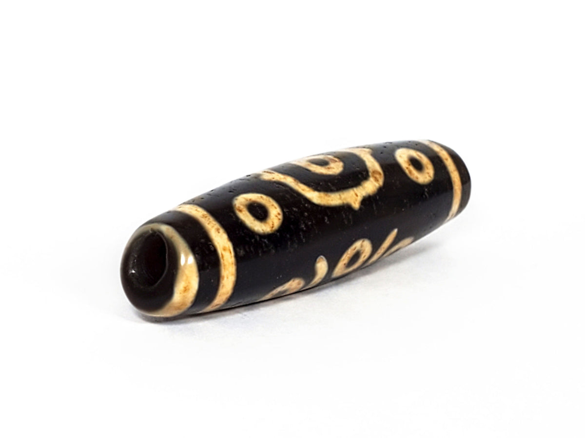 V-FA-062126-14E-LK dzi bead, opposite angled view showing large keyhole drill hole, unretouched
