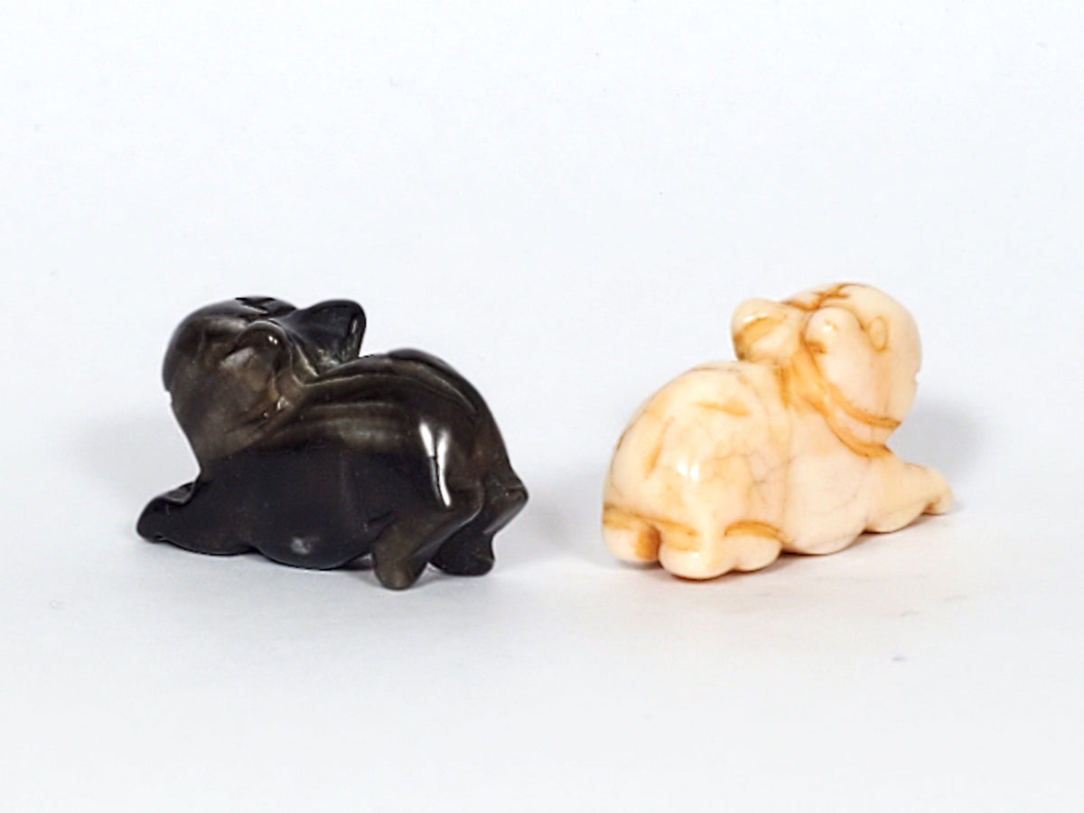 Antique Tibetan carved marmot beads, black and cream agate pair, hand-carved animal figures with patina