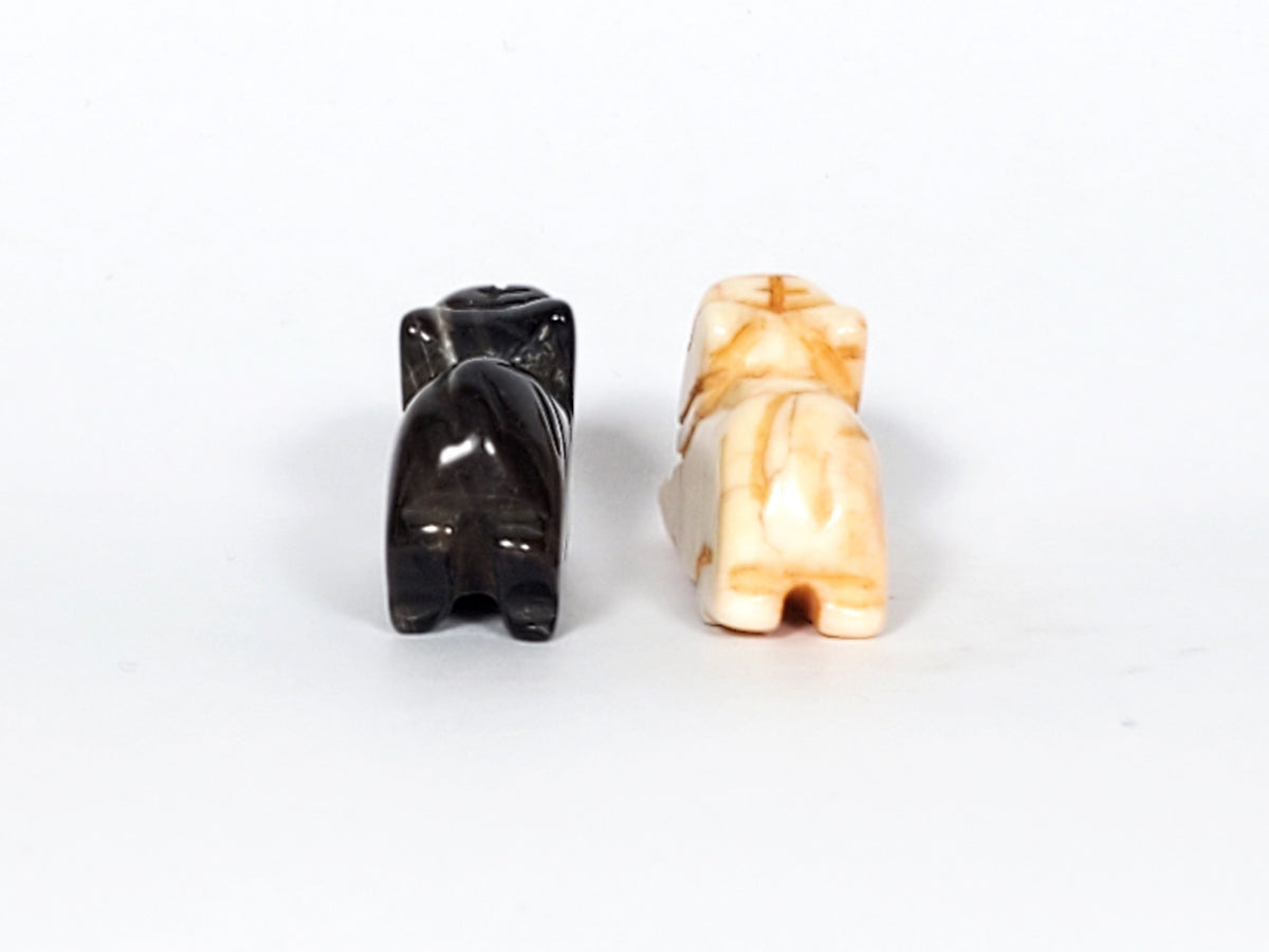 Pair of antique Tibetan carved marmot beads, black and cream agate with natural patina and drill holes