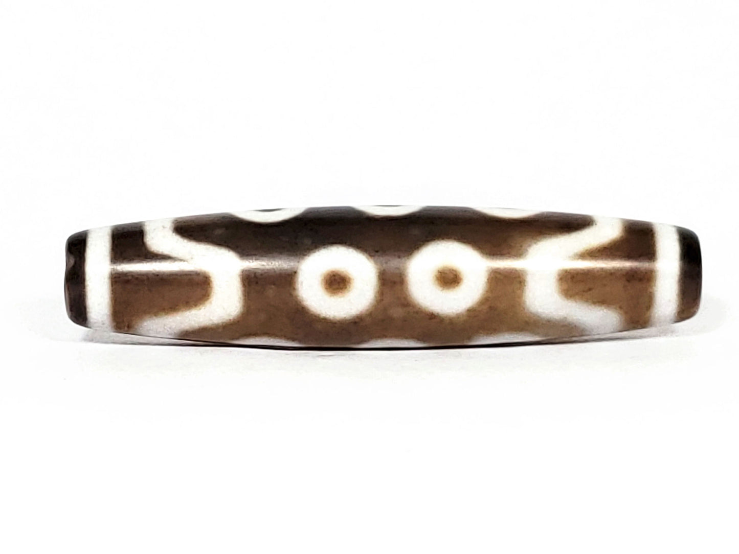 N-062426-10E new ten eye dzi 58.5x13.4mm Face B two eyes with V-shaped connector elements medium brown ground unretouched