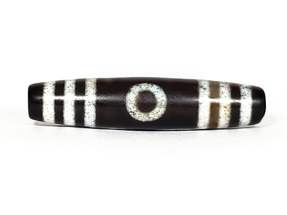 N-062426-3E new three eye dzi 58.6x13.4mm Face A single central eye dark to near-black ground cream motif unretouched