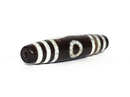 N-062426-3E2 new three eye dzi 57.9x13.3mm angled view narrow pointed end small drill hole near-black tip unretouched