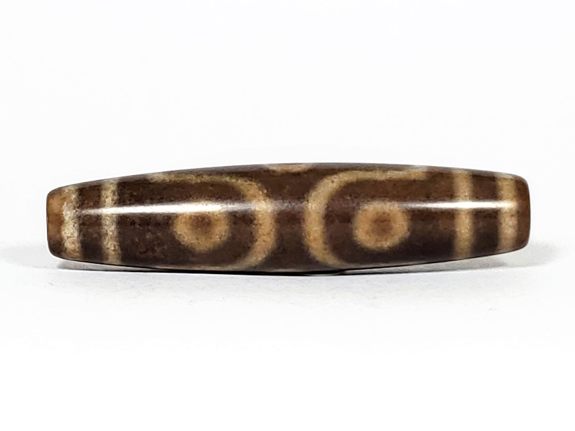 N-062226-6E2, face D, six eye composition, medium warm brown agate, honey-gold motif, asymmetric fusiform, unretouched