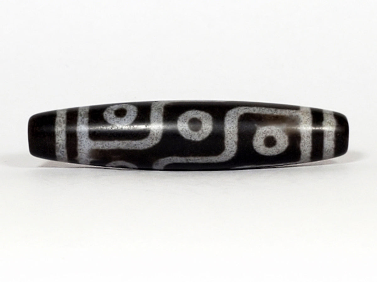 N-062226-9E, nine eye agate dzi, 57.7×12.9mm, deep cool grey-black, silvery-grey motif, face A, unretouched