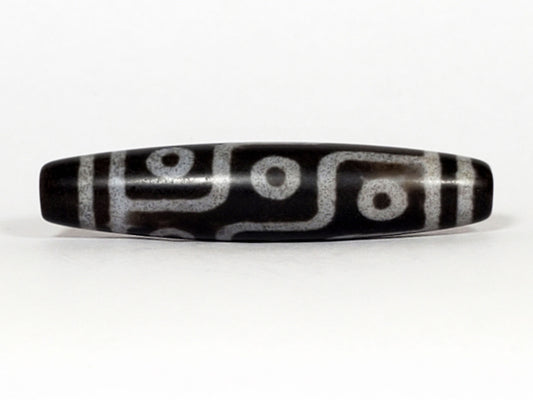 N-062226-9E3, nine eye agate dzi, 58.6×12.9mm, medium-dark warm brown, sandy-cream motif, face A, unretouched