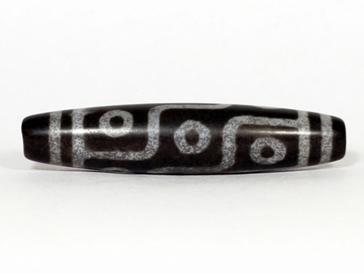 N-062226-9E, face B, nine eye flowing curved-line motif, cool grey-black ground, pale silvery-grey lines, unretouched